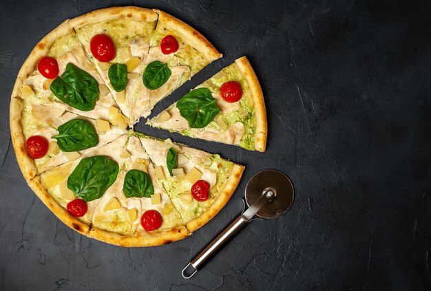 tasty pizza with pineapple, tomatoes, mozzarella cheese, chicken fillet on a stone background with copy space for your text