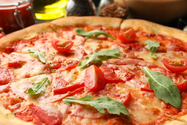 Tasty pizza with tomatoes and arugula leaves