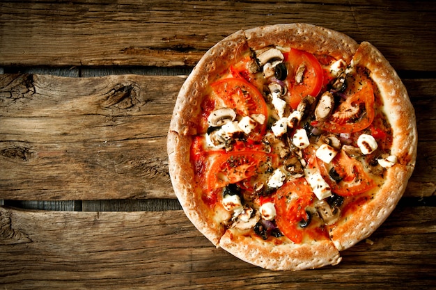 Tasty pizza on wooden board .