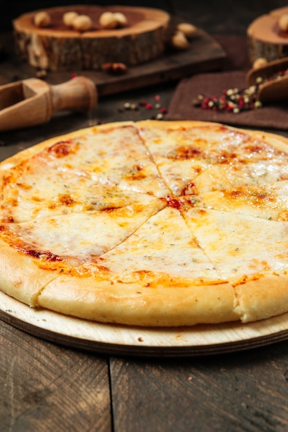 Tasty pizza on the wooden decorated table