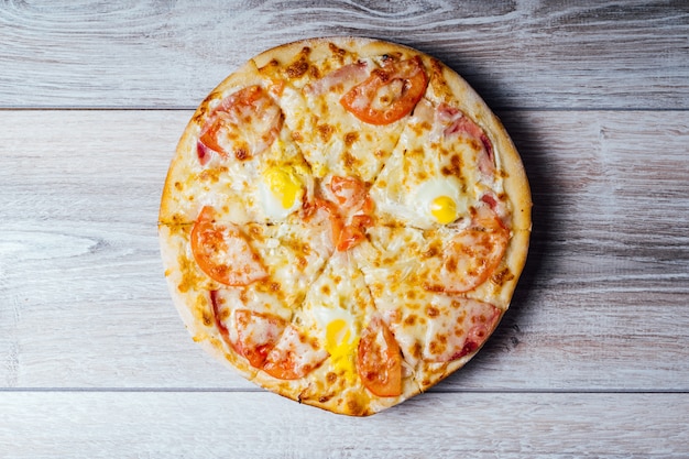 Tasty pizza on wooden . Delicious pizza on wooden table, top view