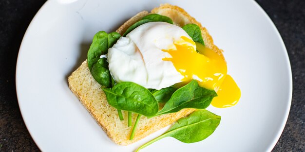 tasty poached egg sandwich spinach on the table