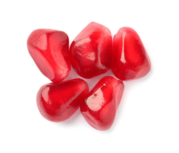 Tasty pomegranate seeds on white background top view