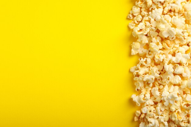 Tasty popcorn on yellow