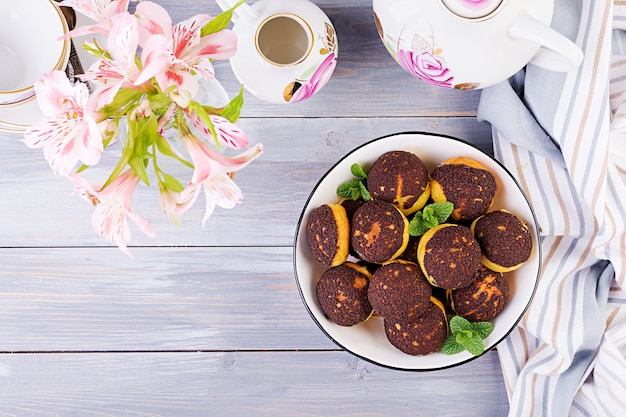 Tasty profiteroles with cream on a plate