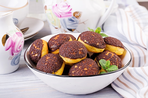 Tasty profiteroles with cream on a plate