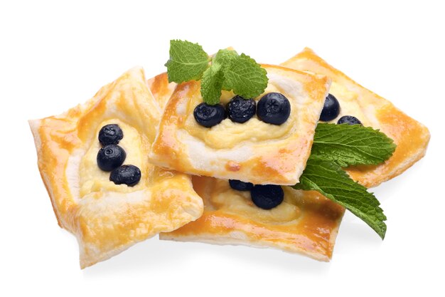 Tasty puff pastry with berries on white background