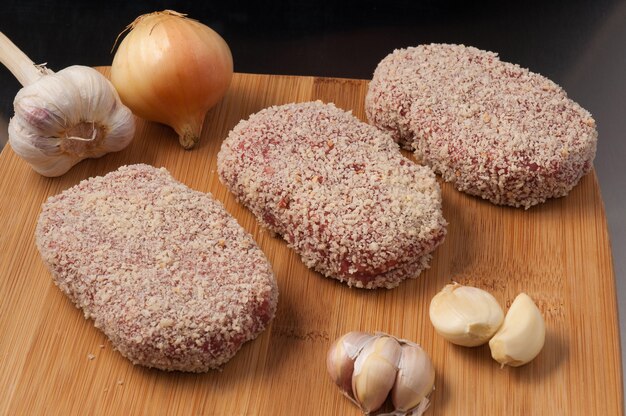 Tasty raw cutlets with onion and garlic in breadcrumbs