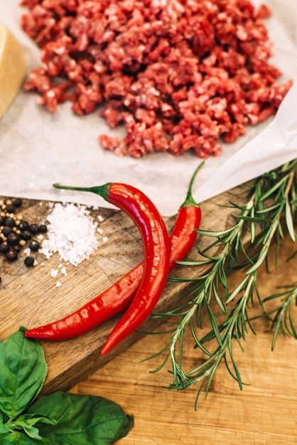 Tasty red hot chilli peppers on a wooden board