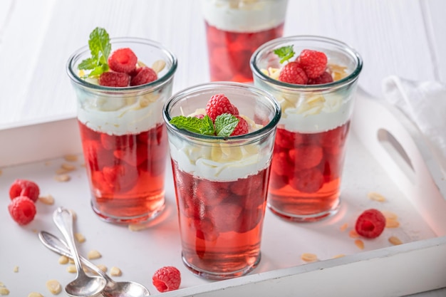 Tasty red jelly as a fruit dessert with cream