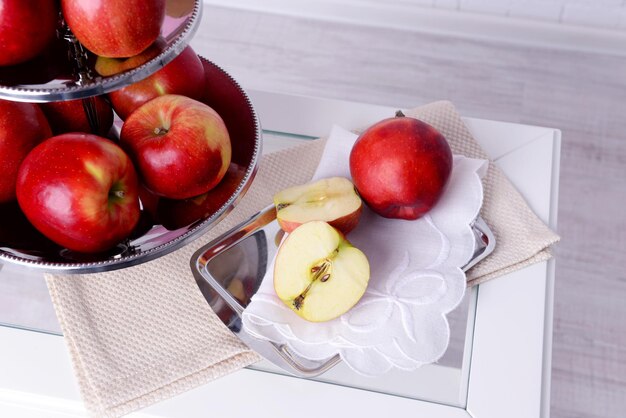 Tasty ripe apples on serving tray on table close up