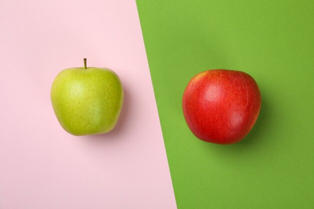 Tasty ripe apples on two tone background