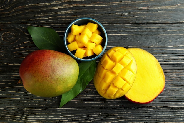 Tasty ripe mango fruit on wooden table