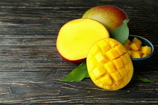 Tasty ripe mango fruit on wooden table