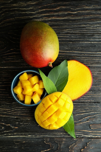 Tasty ripe mango fruit on wooden table