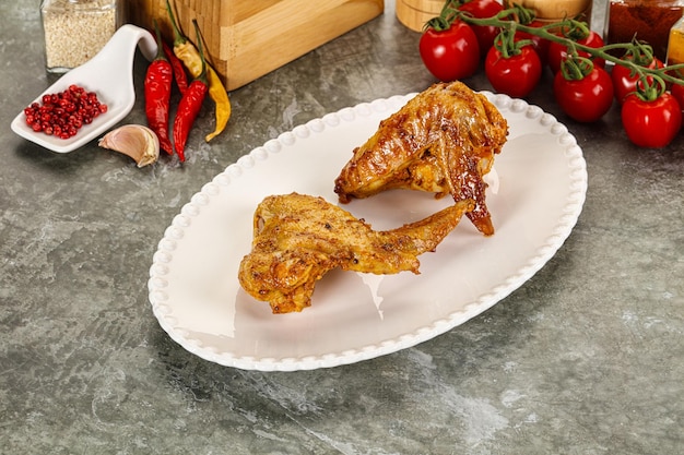 Tasty roasted chicken wing with spices and herbs