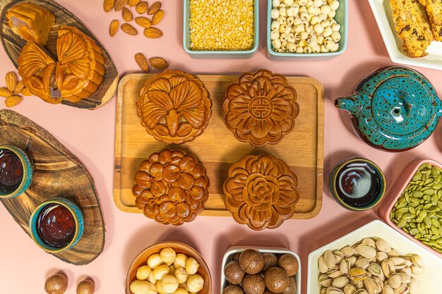 a tasty round moon cakes at mid autumn festival Flat lay mid autumn festival food and drink on sweet pink background Travel holiday food concept