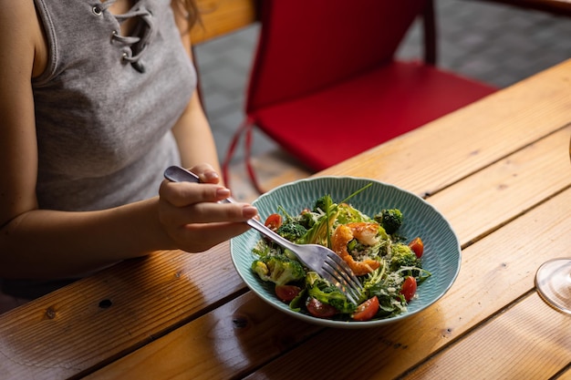 tasty salad in a plate on a brown table