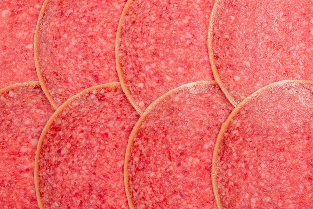 Photo tasty salami slices background.