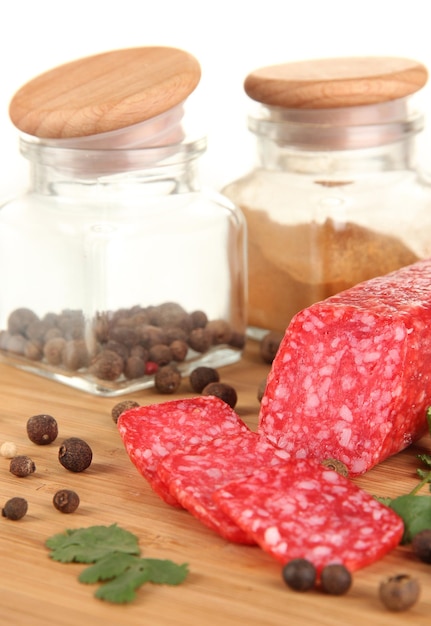 Tasty salami on wooden board isolated on white