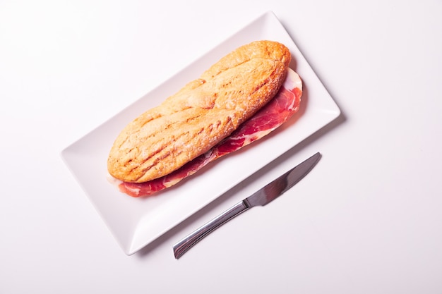 Tasty sandwich made of crispy baguette and ham