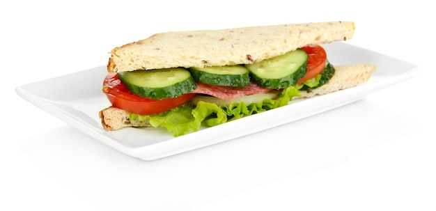 Photo tasty sandwich with salami sausage and vegetables on white plate isolated on white