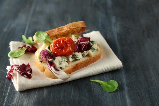 Tasty sandwich on wooden table close up