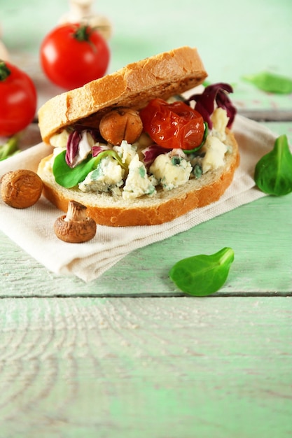 Tasty sandwich on wooden table close up