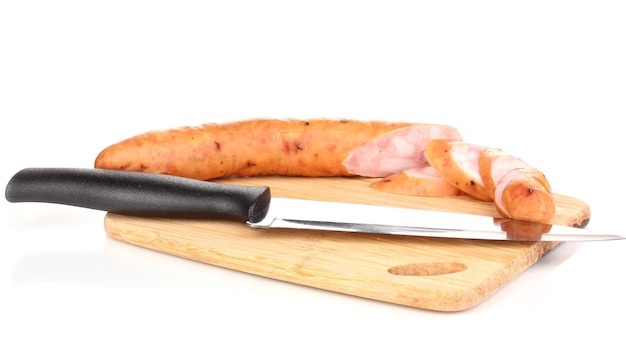 Tasty sausage on chopping board isolated on white