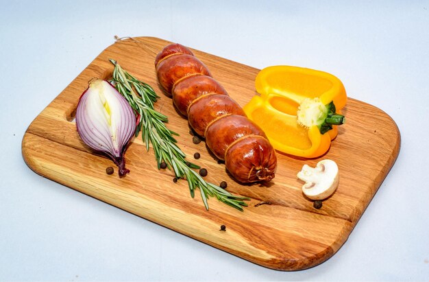 tasty sausages pepper and onion isolated over solid background food photography