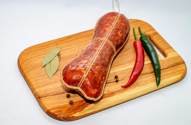 Tasty sausages and vegetables isolated over solid background