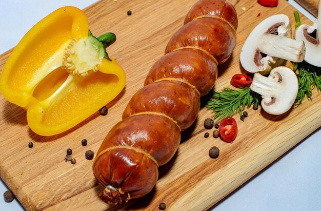 tasty sausages and vegetables isolated over solid background