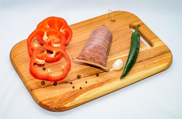 Tasty sausages and vegetables isolated over solid background