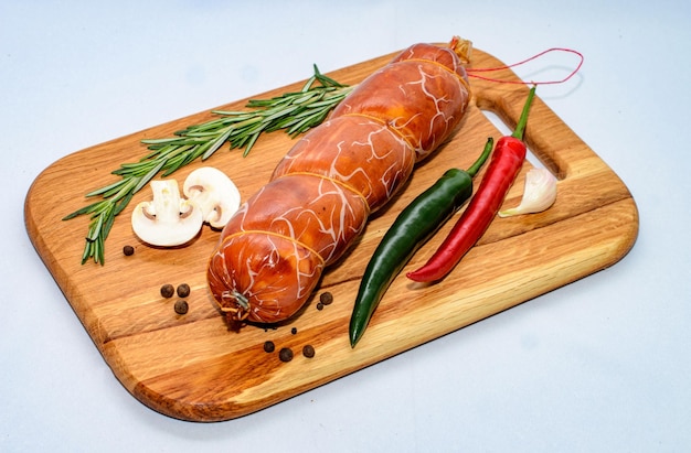 Tasty sausages and vegetables isolated over solid background