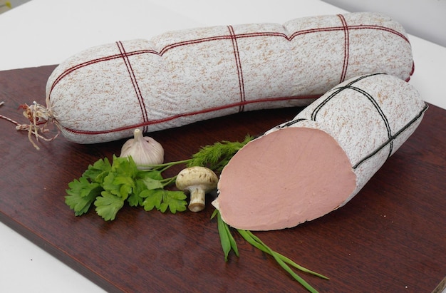 Tasty sausages and vegetables isolated over solid background