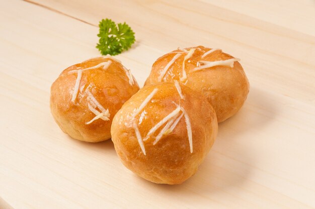 Tasty scones pampushki with garlic on a wooden board