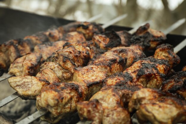 Tasty shashlik is fried on charcoal outdoor