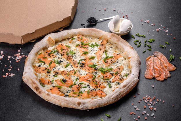 Tasty sliced pizza with seafood and tomato on black background. Mediterranean cuisine