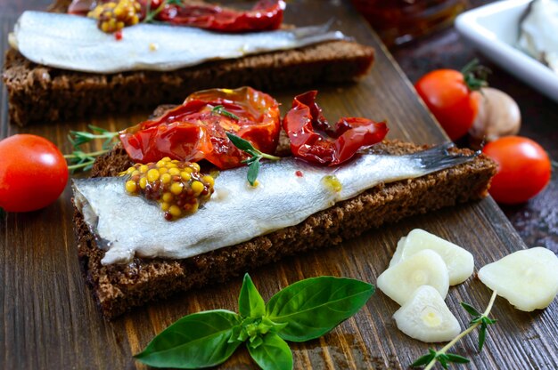 Tasty smorrebrod on a wooden board.