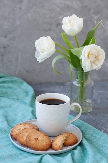 tasty snack. cup of coffee and a plate of cookies.