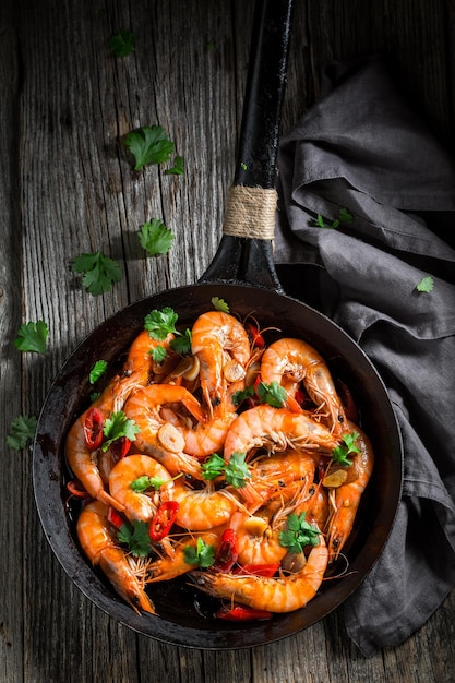 Tasty and spicy shrimps on pan with garlic and coriander