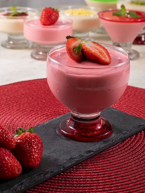Tasty strawberry mousse in glass with strawberry on top.