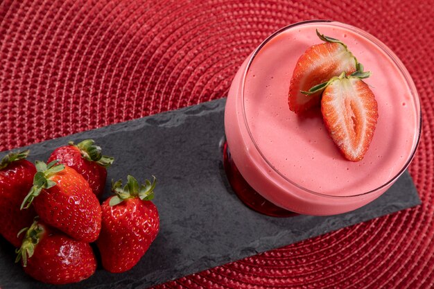 Tasty strawberry mousse in glass with strawberry on top.