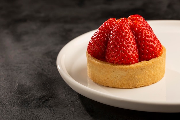 Tasty strawberry tartlet on the table