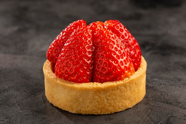 Tasty strawberry tartlet on the table