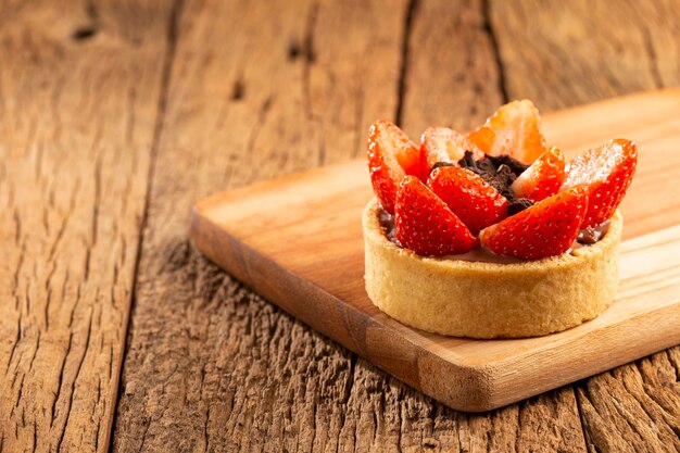 Tasty strawberry tartlet on the table