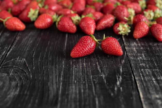 Tasty strawberry on a wooden table. It can be used as a background
