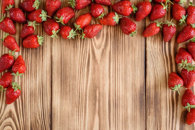 Tasty strawberry on a wooden table.