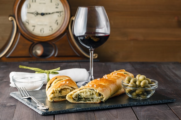 Tasty stuffed bread  and glass of red wine