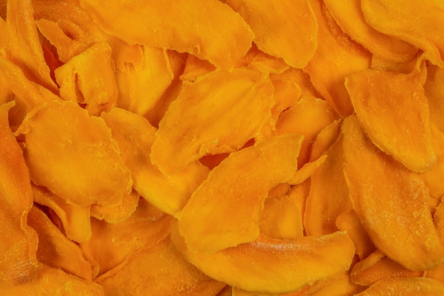 Tasty sugar mango slices background. top view.